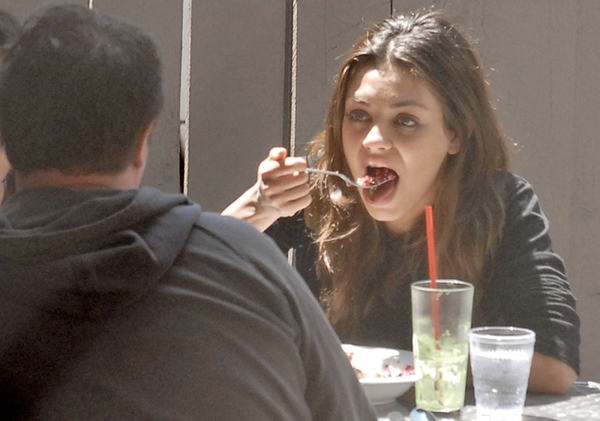 Mila Kunis eating